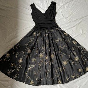 Black cocktail dress with gold detail.